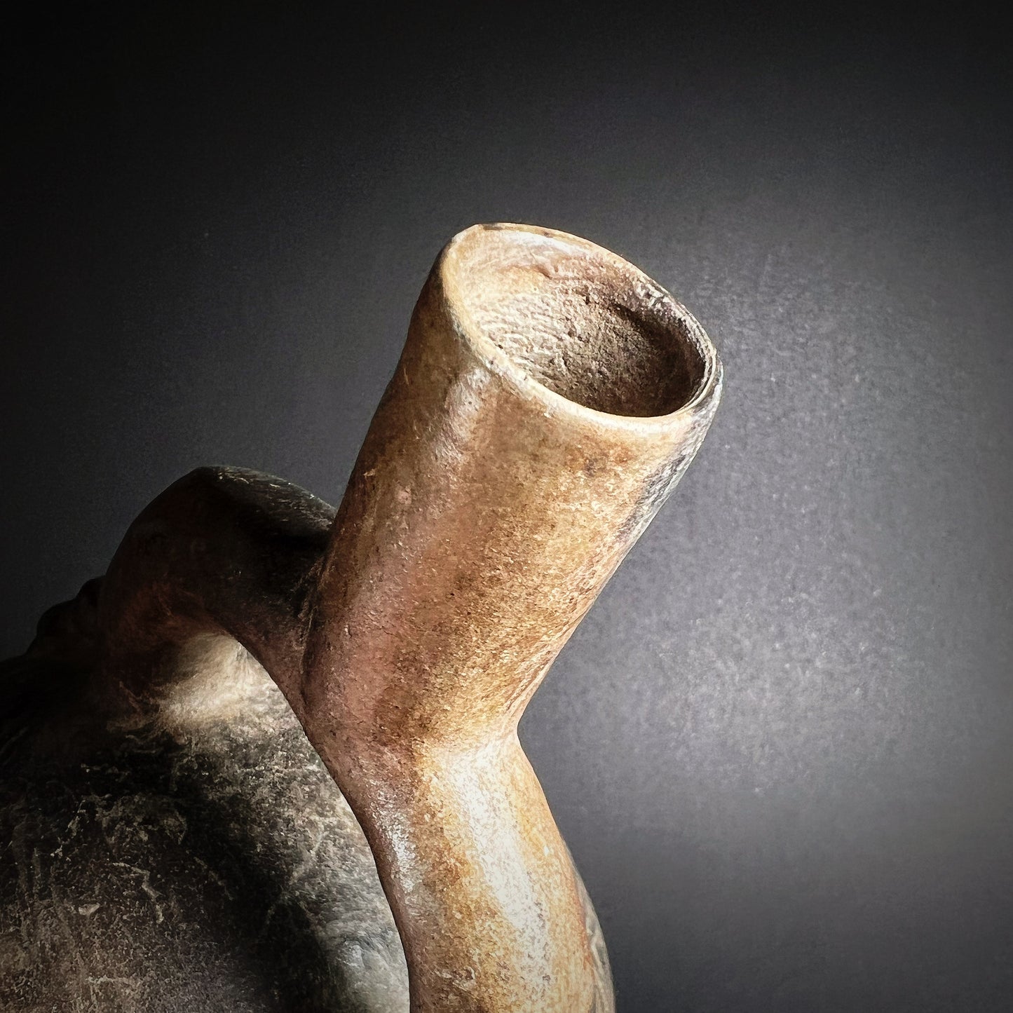 Chimú Blackware Stirrup Spout Vessel with Incised Spiral Motif